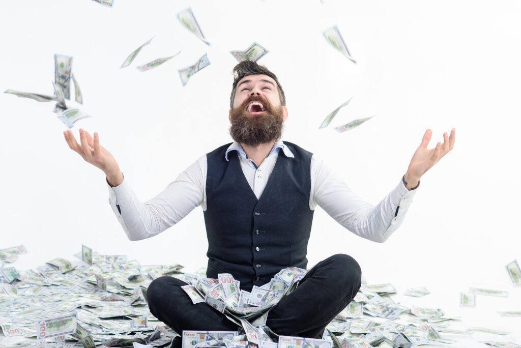 Businessman is happy with his money. Banknotes, cash dollars fly in air. Business success, richness&amp;wealth concept. Very wealthy businessman. Happy businessman winner throws money banknotes. Dollars.